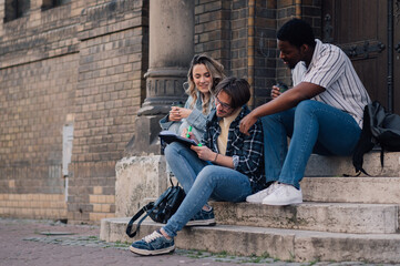 Students studying and drinking coffee on university steps