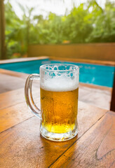 Cold Beer glass on the table at the open-air cafe.
