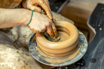 Close-up of male potter's hands making a vase. Pottery. Making ceramics.