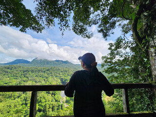 Woman looking over jungle view in Danum Valley view point in Lahad Datu Sabah