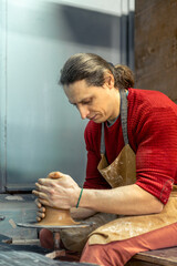 Master male potter making a vase. Pottery. Clay modeling. Creating ceramics.
