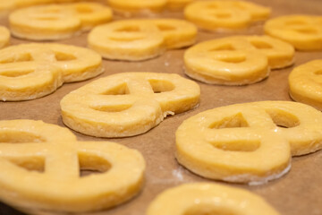 Unbaked butter cookies on parchment paper
