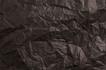 Crumpled black paper texture background
