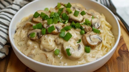 Close up of fettuccine pasta with creamy chanterelle mushroom sauce and garnished with green onions, quick meal