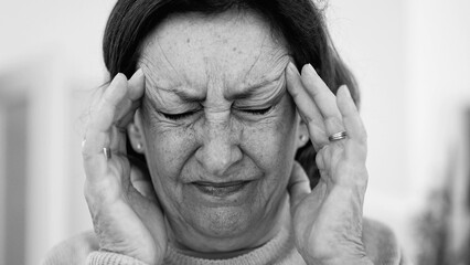 Elderly woman in visible distress, grimacing while holding head with both hands, eyes squeezed shut, intense focus on pain relief. Wrinkles and facial expression, headache or stress-SD 480p