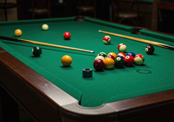 Pool table: Green felt, bright red pool ball near pocket, wooden cues resting on the table's edge.