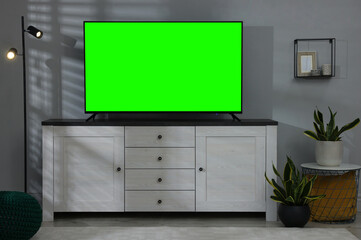 TV set with green screen on stand in room. Chroma key compositing