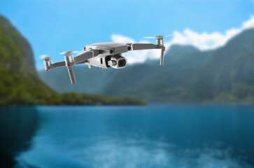 Drone with camera flying over bay. Unmanned aerial vehicle for surveillance