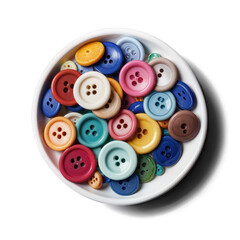 A white bowl filled with an assortment of colorful sewing buttons in various sizes, arranged randomly and viewed from above on a white background.