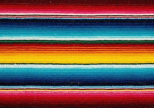Close-up view of a colorful, striped Mexican serape textile background with vibrant hues.