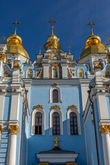 Beautiful blue Facade and golden Domes of the of St. Michael's Golden-Domed Monastery in the City Center of Kyiv, Ukraine; perfect blue Sky