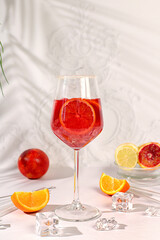Royal cocktail aperol sprits with blood orange, ice cubes, rum and tequila. Summer party and restaurant relaxation concept. Banner with glasses of alcoholic drinks and tropical fruits. Menu for a bar