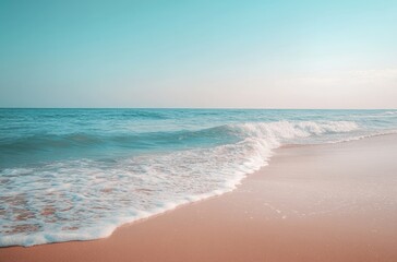 Fototapeta premium Tranquil beach scene with soft waves lapping gently on the shore.