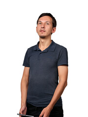 A Confident Young Man Dressed in Casual Attire Holding a Tablet in a Modern Setting