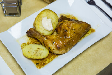 Fried chicken legs with boiled potatoes and sauce. High quality photo