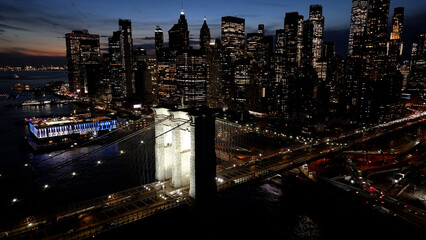 Fototapeta premium Night Scape Of Brooklyn Bridge At Manhattan In New York United States. City At Night Scene. Illuminated Bridge Landscape. Brooklyn Bridge At New York United States. Highrise Buildings. 