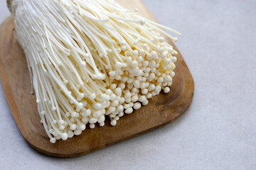 Fresh Enoki mushrooms on white background