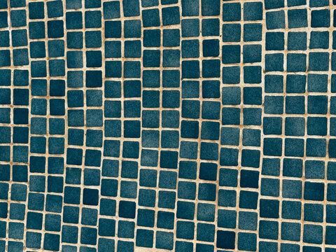 Blue square tiles forming a geometric pattern surface