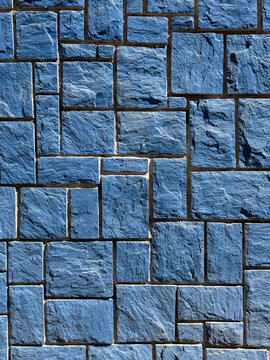 Blue textured stone wall in interlocking pattern
