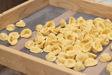 Orecchiette, a type of Italian pasta. Demonstration of the famous Apulian orecchiette common in Italy. Varieties of fresh pasta. Italian pasta in the shape of small ears. Handmade orecchiette pasta