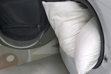 White pillows in washing machine.