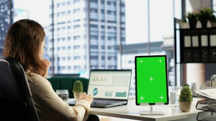 General director using chroma key template on modern gadget, developing her business within the...