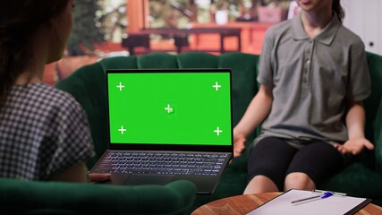 Therapist uses green screen display in a counseling session with an adolescent dealing with low confidence. Psychotherapist supports her in building resilience and self esteem. Camera A.