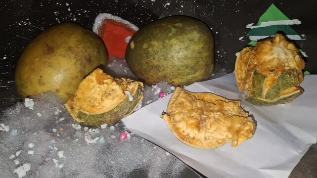 Aegle marmelos, or wood apple, is a sacred Indian fruit with hard shell, aromatic pulp, medicinal properties, and cooling effects.