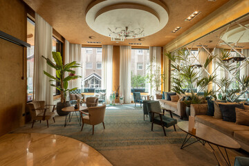 Elegant hotel lobby with stylish furniture and indoor plants