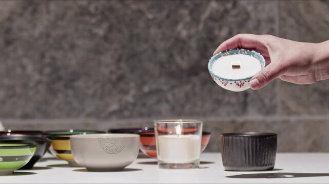 Woman Lights the Candle with Her Hand and Puts it on the Table Footage.