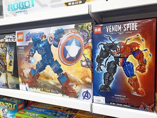 Naklejka premium Marvel-themed robot building kits displayed on toy store shelf