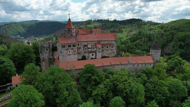 Pernstejn Castle a stunning aerial panorama in the Czech Republic, capturing the grandeur of its Gothic-Renaissance architecture surrounded by lush forests.