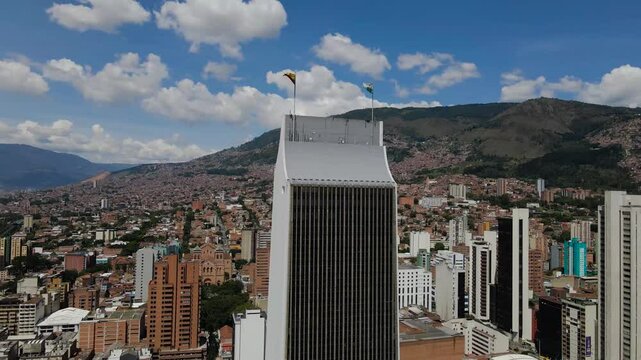 Aerial footage of the Coltejer Building in the downtown of Medellin city, Colombia on a sunny day