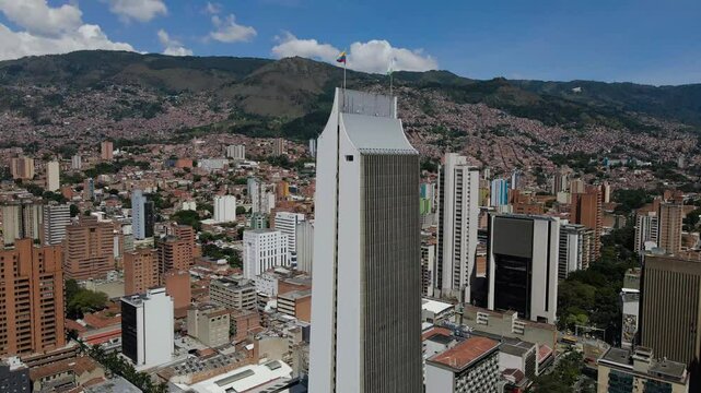 Drone footage of the Coltejer Building in the downtown of Medellin city, Colombia on a sunny day