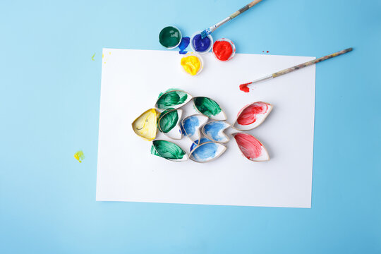handmade fish craft from recycled toilet paper roll painted by child. fun DIY project for eco-friendly education, school lessons, summer camp activities, art studios, recycling awareness programs,