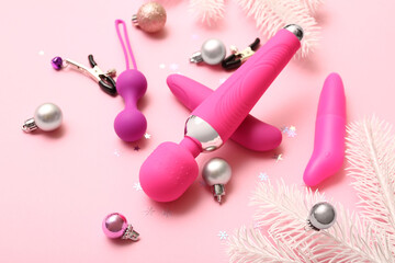 Sex toys and Christmas decor on pink background