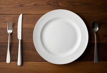 A white plate with a fork and knife was placed on the table