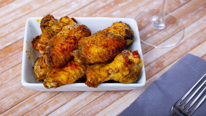 Appetizing crispy deep fried chicken wings served on plate. Popular snack