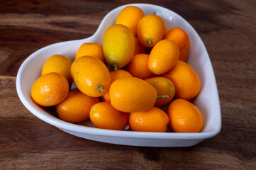 Delicious small citrus fruits orange kumquats close up