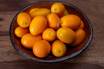 Delicious small citrus fruits orange kumquats close up