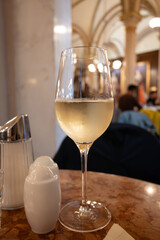 Lifestyle of beautiful Vienna, glass of cold white dry Austrian wine served in old Viennese-style...