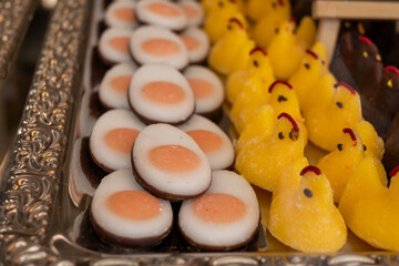 Various Easter-themed confectionery, marmalade chickens, chocolates and eggs, on display counter in old traditional candy shop in Vienna, Austria