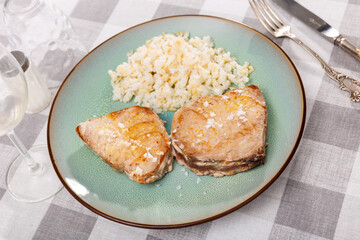 Two pieces of juicy grilled tuna steaks served with rice in cafe