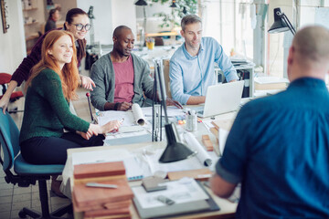 Obraz premium Group of people working together on a project in a startup company office