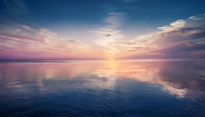 tranquil pastel sunset reflected on the calm ocean surface