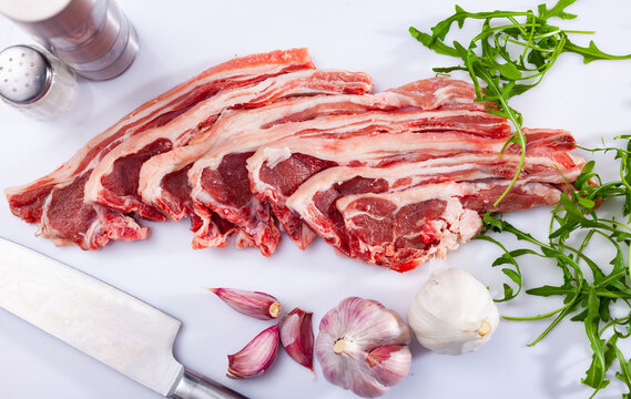 Fresh raw lamb ribs for chops with garlic and herbs. Ingredients for cooking delicious dishes