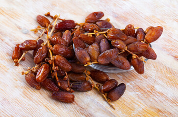 Close up of tropical dried fruits Kurma or dates on table, nobody