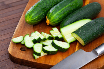 Vegetable ingredients for cooking, sliced cucumbers on wooden table
