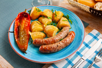 Fried meat sausage served with oven baked potato, pepper and parsley