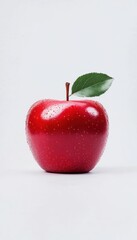 Vibrant red apple with leaf, studio shot